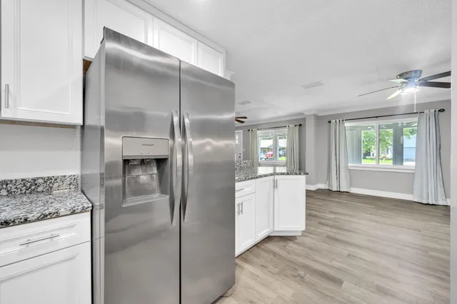 a kitchen with a refrigerator and a sink