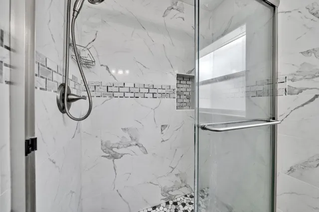 a bathroom with a glass shower door