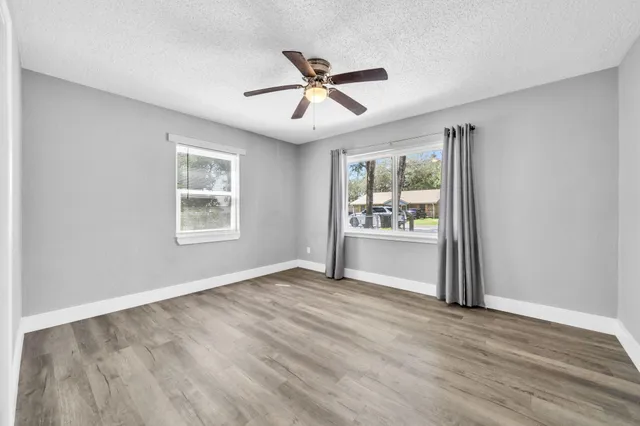 wooden floor in an empty room with a window