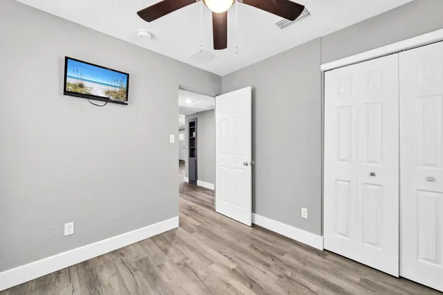 a view of empty room with wooden floor