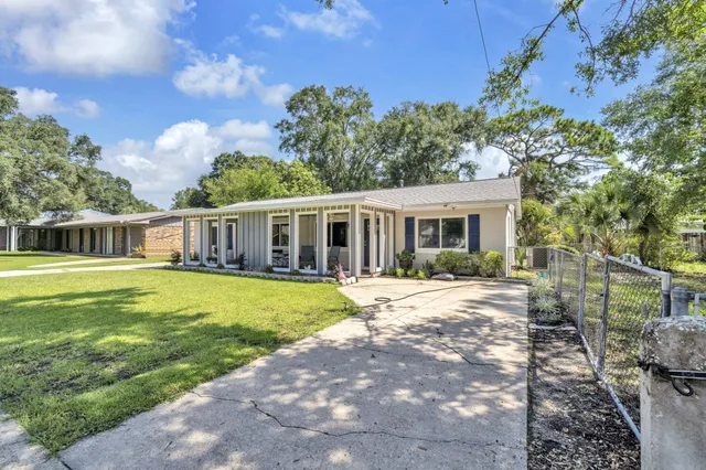 a front view of a house with a garden