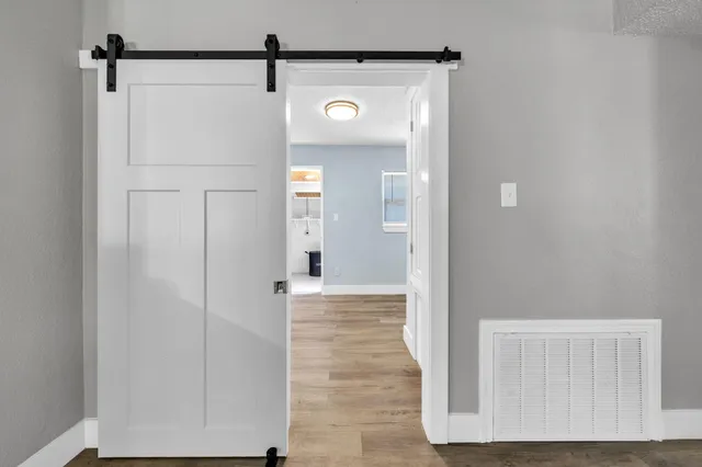 a view of a hallway with wooden floor