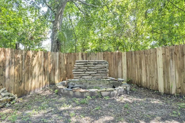 a view of small yard with wooden fence