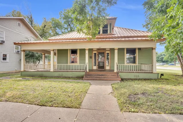 a view of a house with a large window and a yard