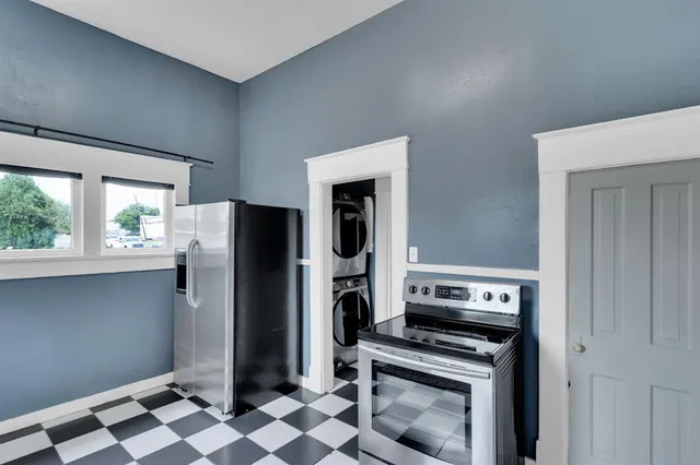 a kitchen with stainless steel appliances granite countertop a refrigerator and a stove top oven