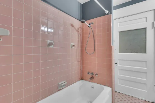 a bathroom with a bathtub and a shower