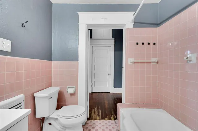 a bathroom with a toilet and a shower