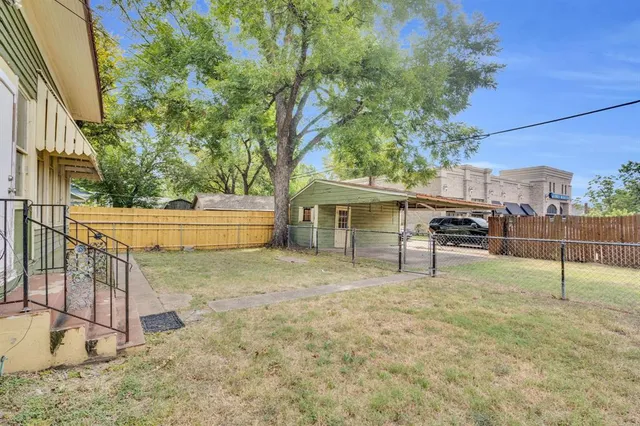 a backyard of a house with table and chairs