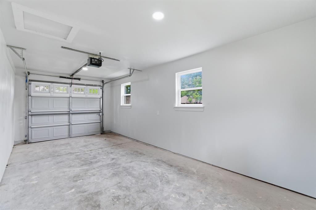 507 Country Club Road Cleburne, TX 76033 - Photo 32 of 39 Spacious garage featuring a concrete floor, two windows, recessed lighting, and an automatic garage door opener