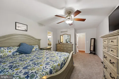 a bedroom with a large bed and a tv