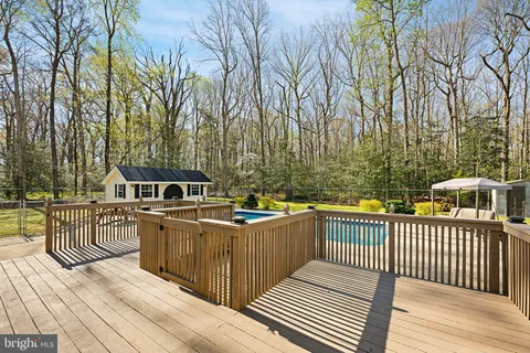a view of a roof deck with wooden floor and fence