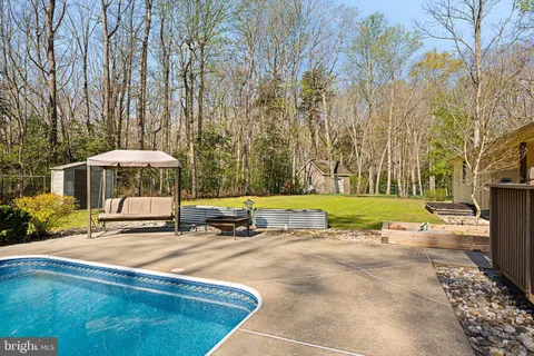 a view of a swimming pool with a yard