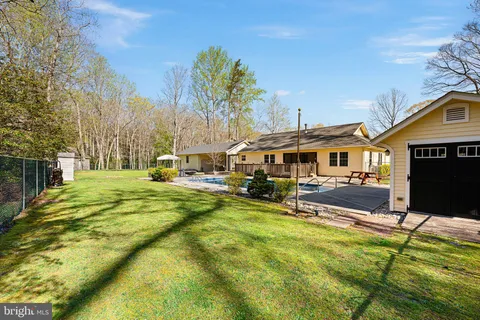 a view of a house with swimming pool and sitting area