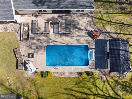 a building outdoor space with swimming pool in the background