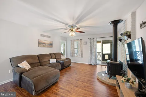 a living room with furniture and wooden floor