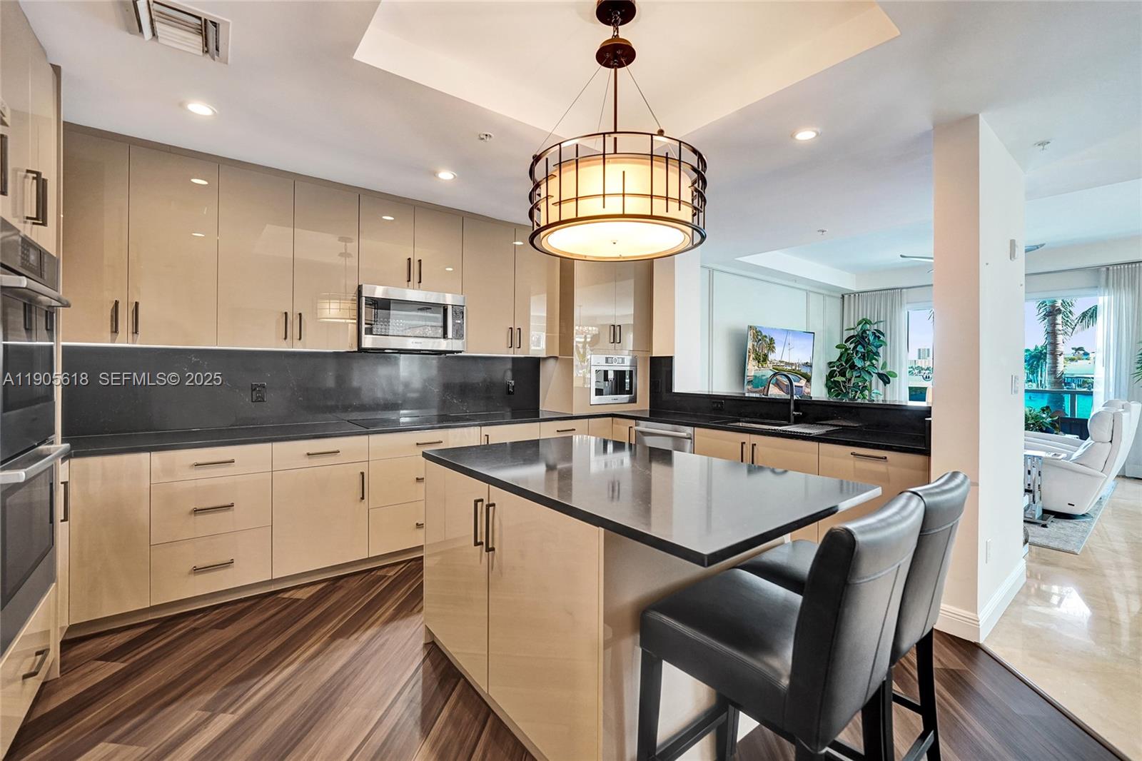 516 Hendricks Isle, Unit 2C Fort Lauderdale, FL 33301 - Photo 11 of 77 a kitchen with kitchen island stainless steel appliances a table chairs sink and stove top oven