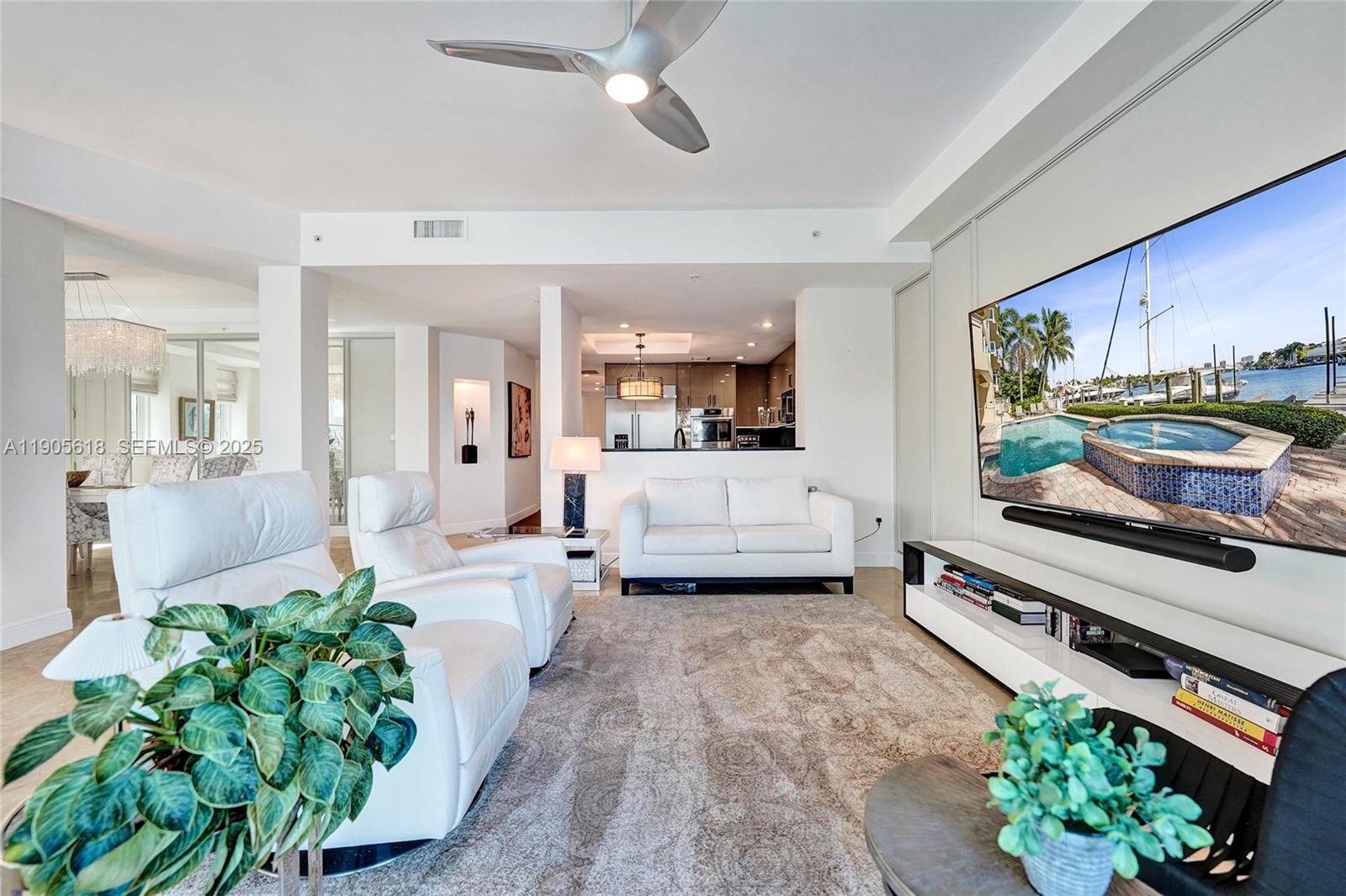 516 Hendricks Isle, Unit 2C Fort Lauderdale, FL 33301 - Photo 24 of 77 a living room with furniture and a flat screen tv