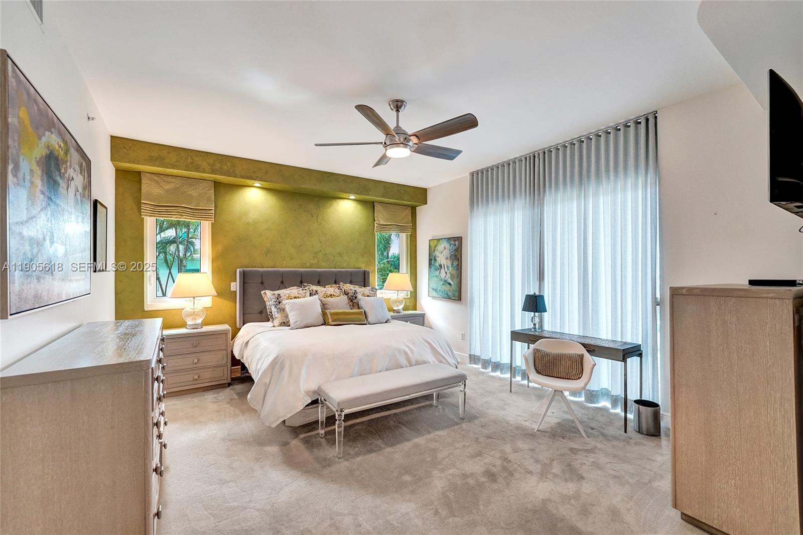 516 Hendricks Isle, Unit 2C Fort Lauderdale, FL 33301 - Photo 36 of 77 a bedroom with a bed and a chandelier