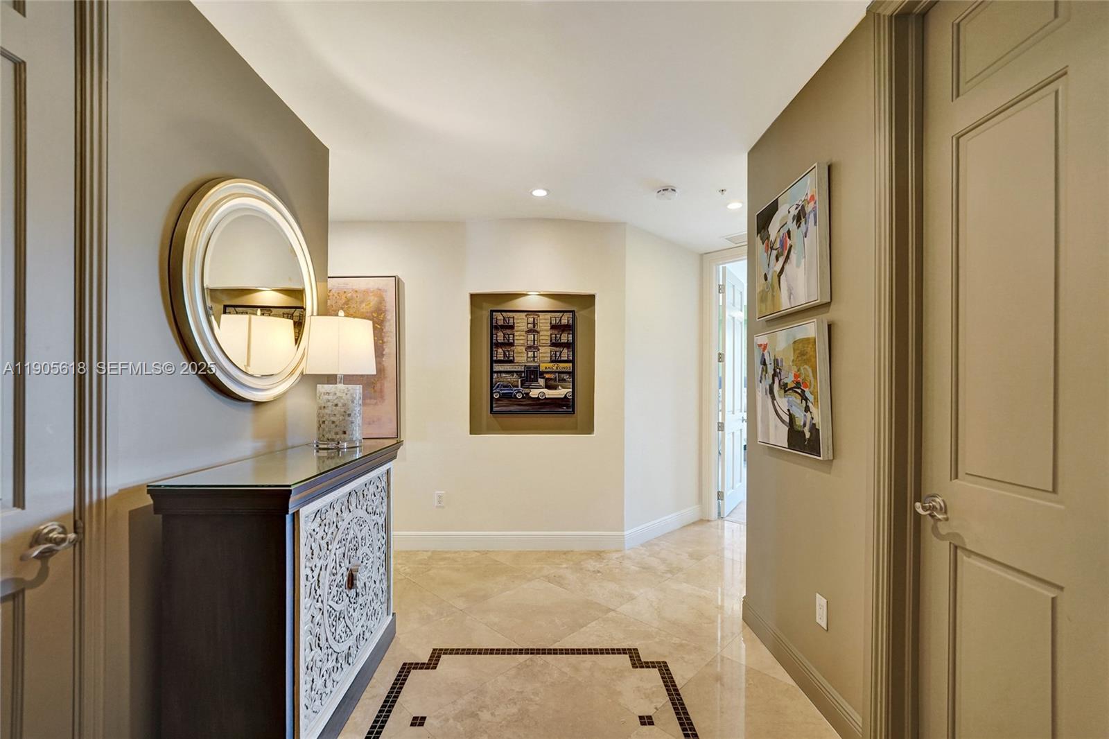 516 Hendricks Isle, Unit 2C Fort Lauderdale, FL 33301 - Photo 52 of 77 a view of a livingroom with wooden floor and a mirror