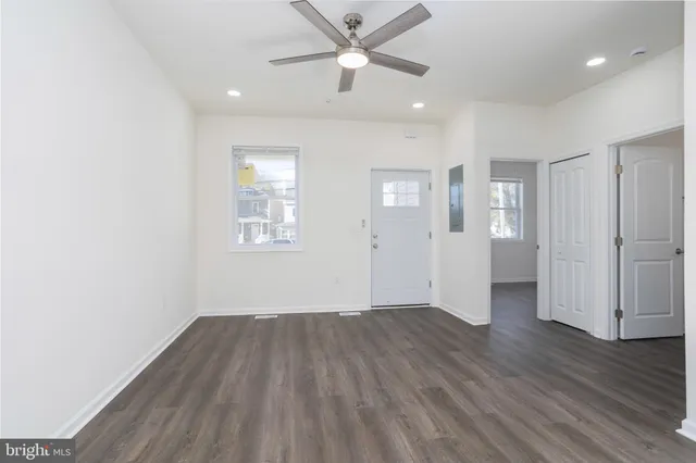 an empty room with wooden floor a ceiling fan and closet