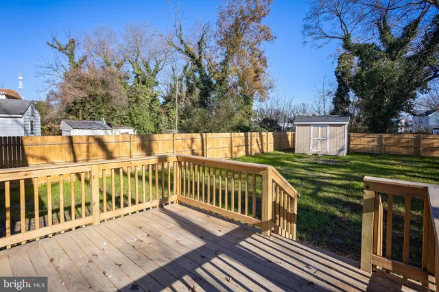 a view of a wooden deck with a yard