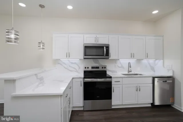 a kitchen with a sink a stove and cabinets