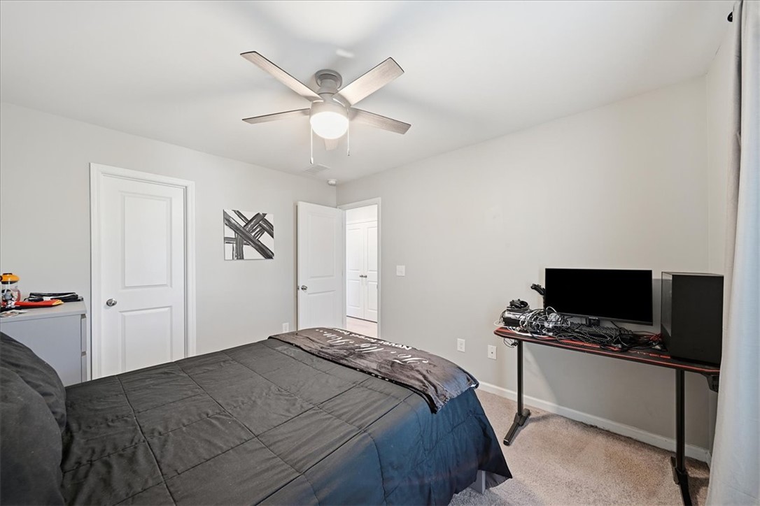208 Grassy Creek Way Pendleton, SC 29670 - Photo 32 of 43 A comfortable bedroom features carpet flooring and a ceiling fan for year-round comfort.