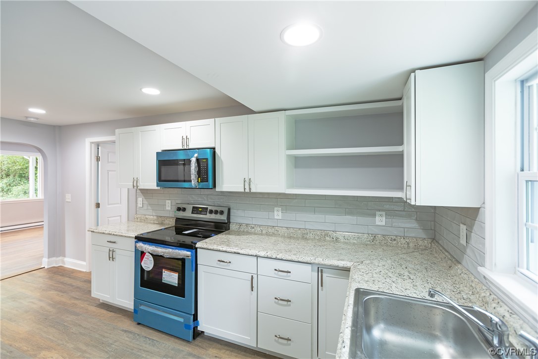 2440 Dupuy Road Petersburg, VA 23803 - Photo 17 of 25 a kitchen with granite countertop a sink stainless steel appliances and cabinets