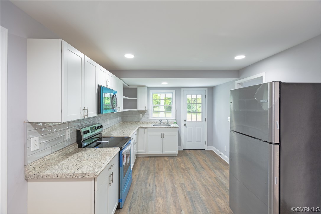 2440 Dupuy Road Petersburg, VA 23803 - Photo 18 of 25 a kitchen with stainless steel appliances granite countertop a refrigerator sink and wooden cabinets