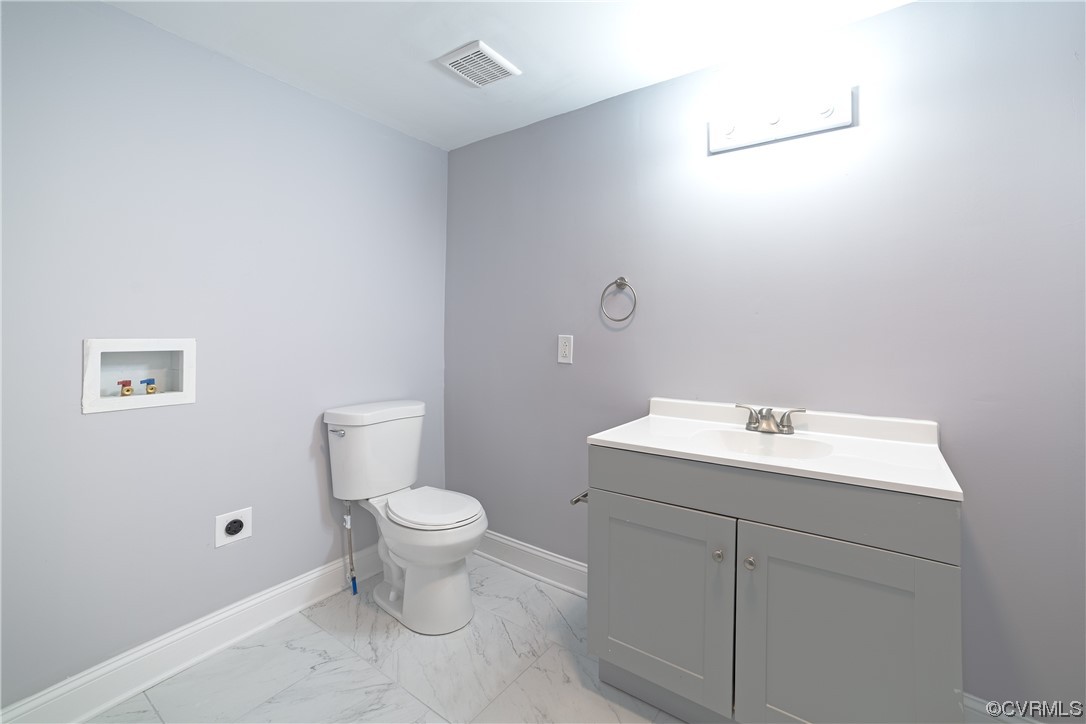 2440 Dupuy Road Petersburg, VA 23803 - Photo 21 of 25 a bathroom with a toilet sink and mirror