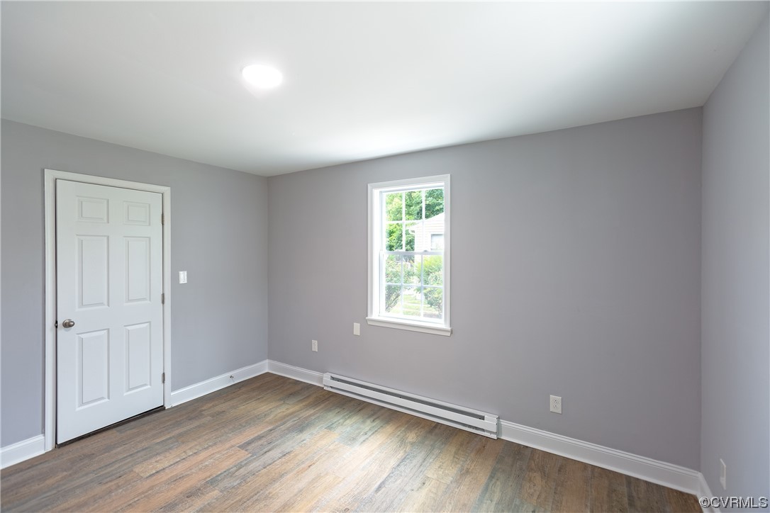 2440 Dupuy Road Petersburg, VA 23803 - Photo 9 of 25 an empty room with wooden floor and windows