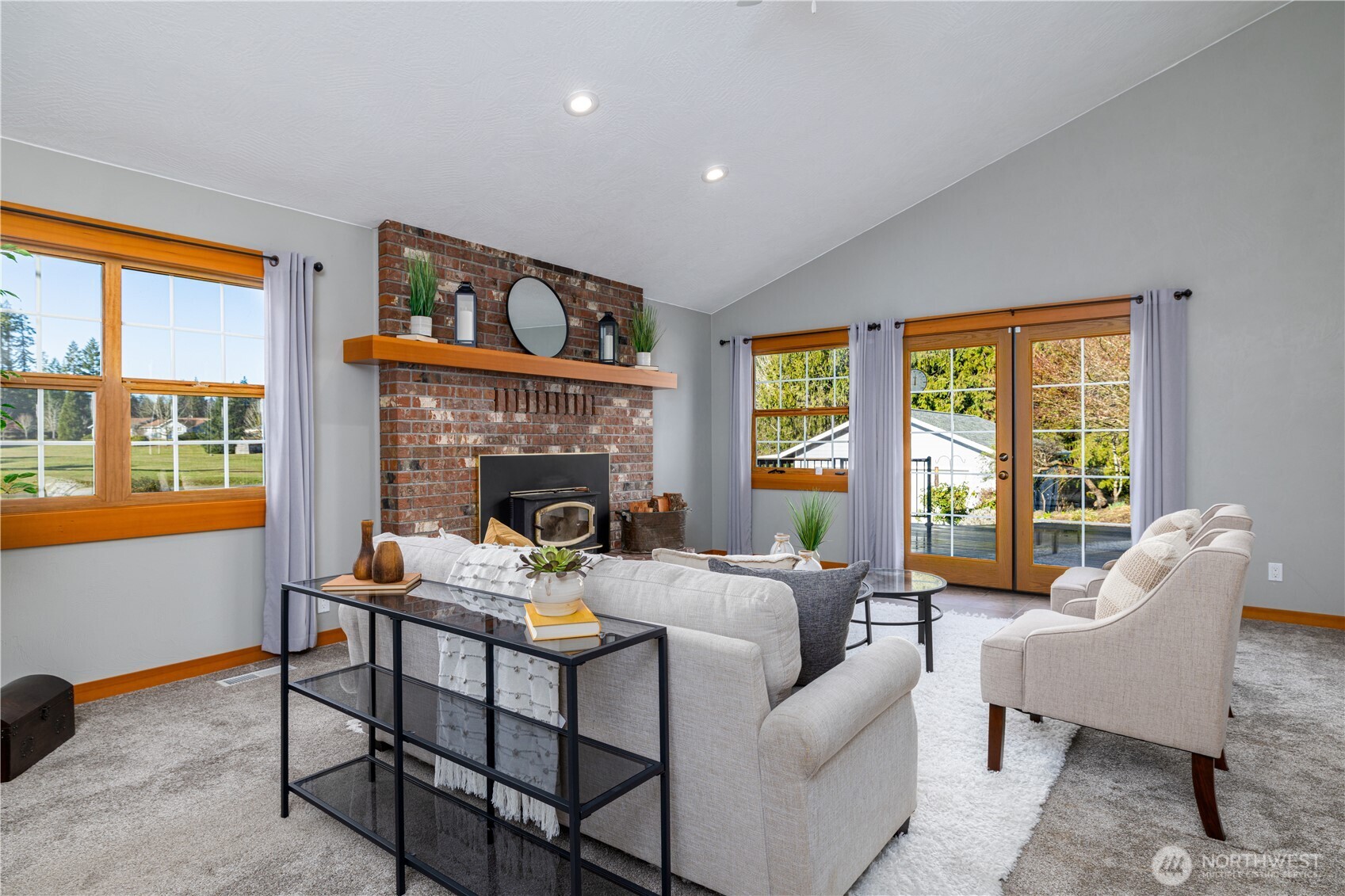 5981 Southeast Arcadia Road Shelton, WA 98584 - Photo 11 of 35 a living room with furniture a fireplace and a floor to ceiling window