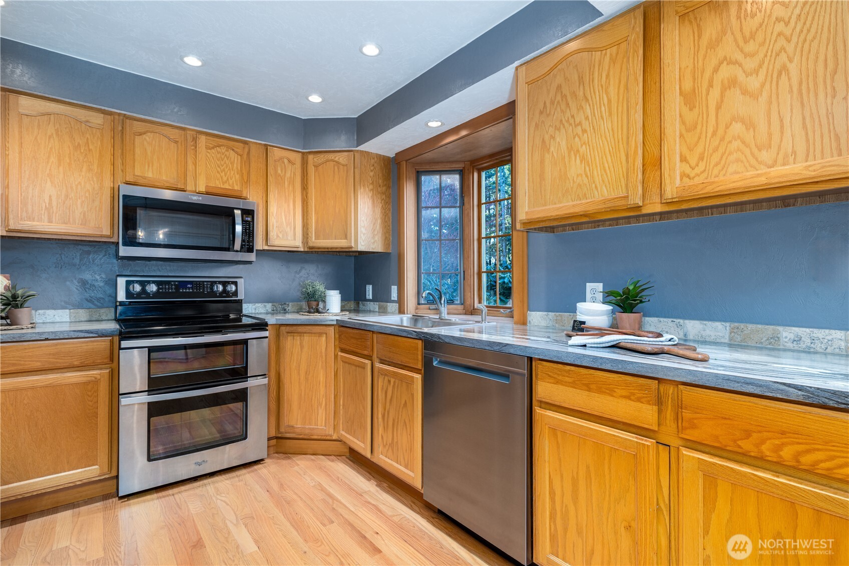 5981 Southeast Arcadia Road Shelton, WA 98584 - Photo 8 of 35 a kitchen with stainless steel appliances granite countertop a stove a sink and a microwave
