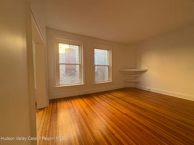 a kitchen with white cabinets and appliances