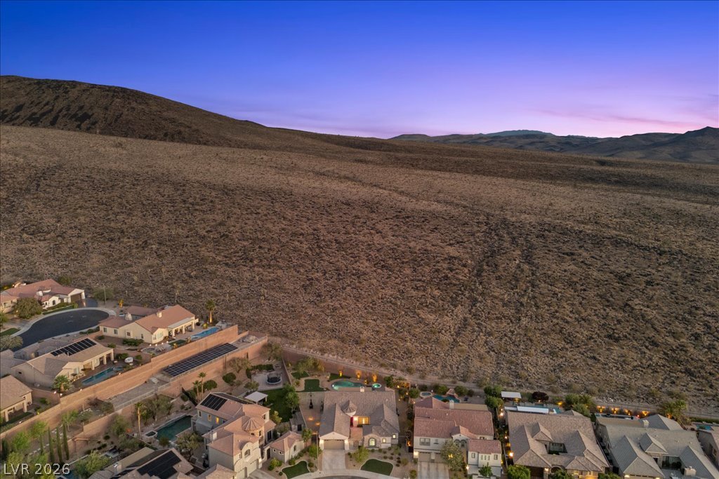 2125 De Rouge Avenue Henderson, NV 89044 - Photo 91 of 96 Perched below towering desert mountains, this hillside community offers private residences with resort-like amenities.