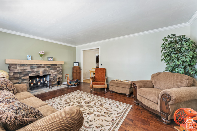 8843 Capernaum Road West Jordan, UT 84088 - Photo 5 of 31 Living room with hardwood / wood-style flooring, crown molding, and a fireplace