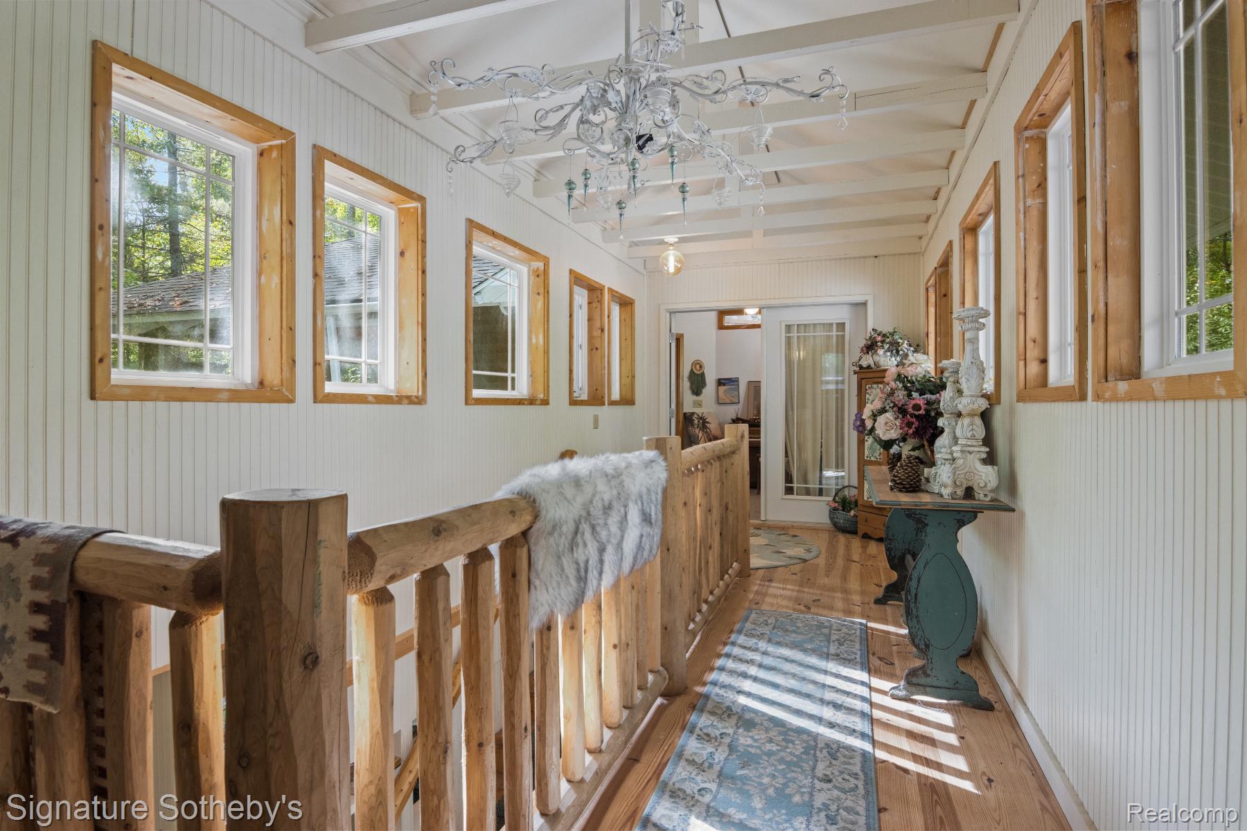 11436 Lakeview Road Northeast Kalkaska, MI 49646 - Photo 17 of 29 Corridor featuring hardwood / wood-style floors, beam ceiling, and wood walls