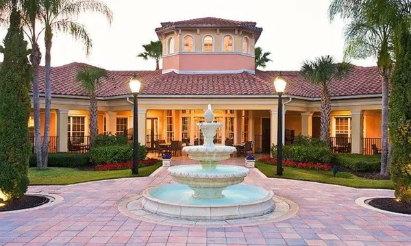 a view of a house with backyard porch and sitting area