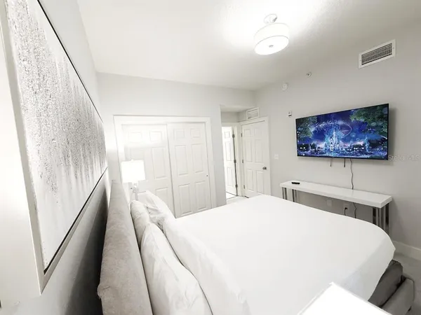 a spacious bedroom with a bed and a large window