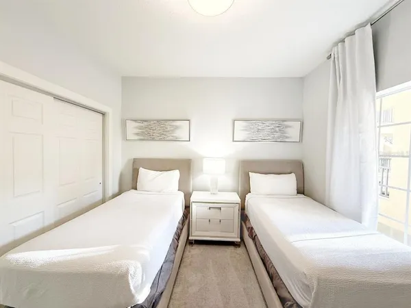 a room with a bed and a large window