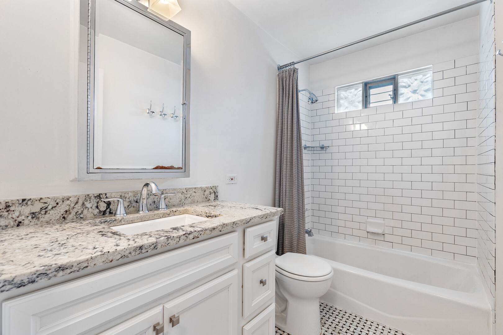 17 North Pine Street Mount Prospect, IL 60056 - Photo 12 of 32 a bathroom with a granite countertop toilet a sink and a bathtub