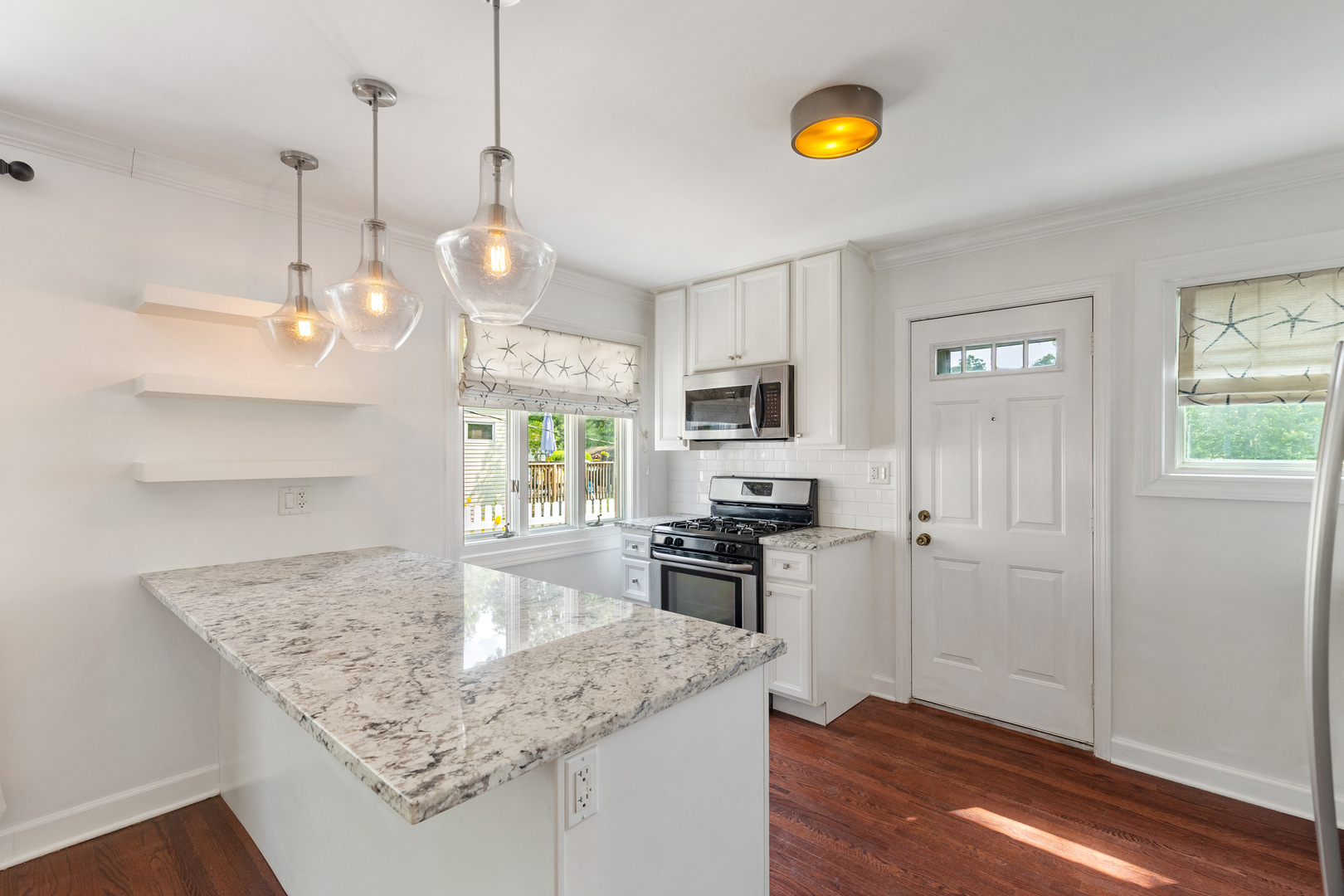 17 North Pine Street Mount Prospect, IL 60056 - Photo 2 of 32 a kitchen with stainless steel appliances granite countertop a stove a refrigerator a sink a microwave oven with a dining table and chairs with wooden floor