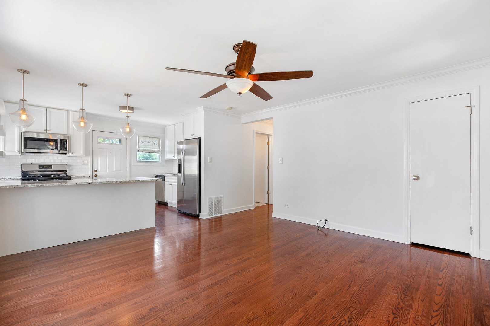 17 North Pine Street Mount Prospect, IL 60056 - Photo 10 of 32 a view of a kitchen with wooden floor and a ceiling fan