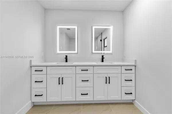 a bathroom with a double vanity sink mirror and