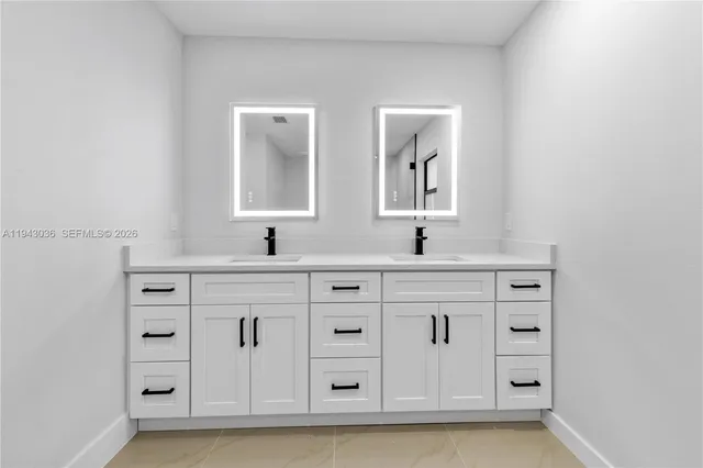 a bathroom with a double vanity sink mirror and
