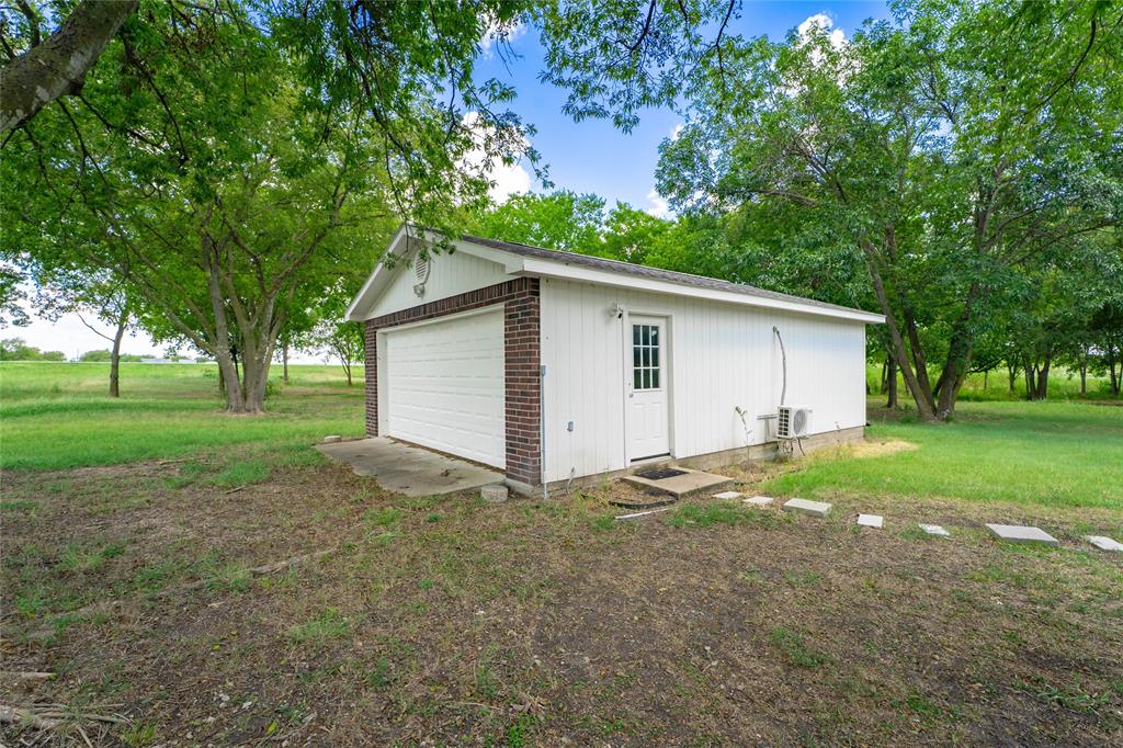 135 Kirkpatrick Road Ennis, TX 75119 - Photo 37 of 40 a view of a house with backyard and trees