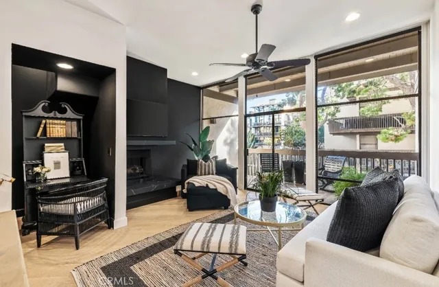 a living room with furniture fireplace and flat screen tv