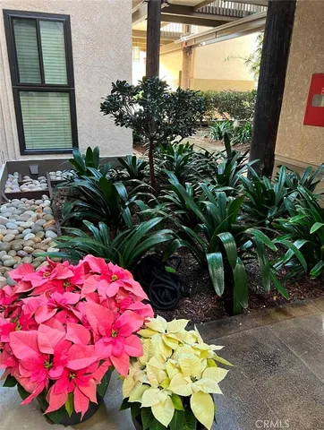 a vase of flowers sitting in a yard