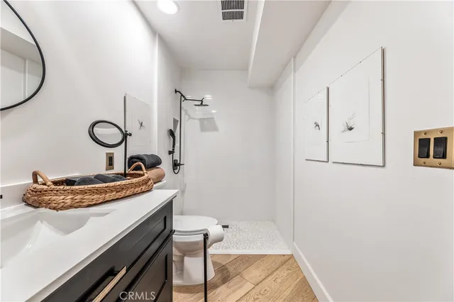 a bathroom with a sink mirror and toilet