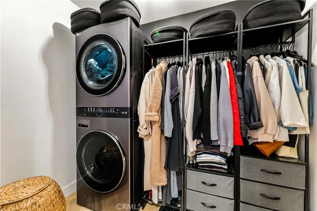a view of walk in closet with clothes and shoes